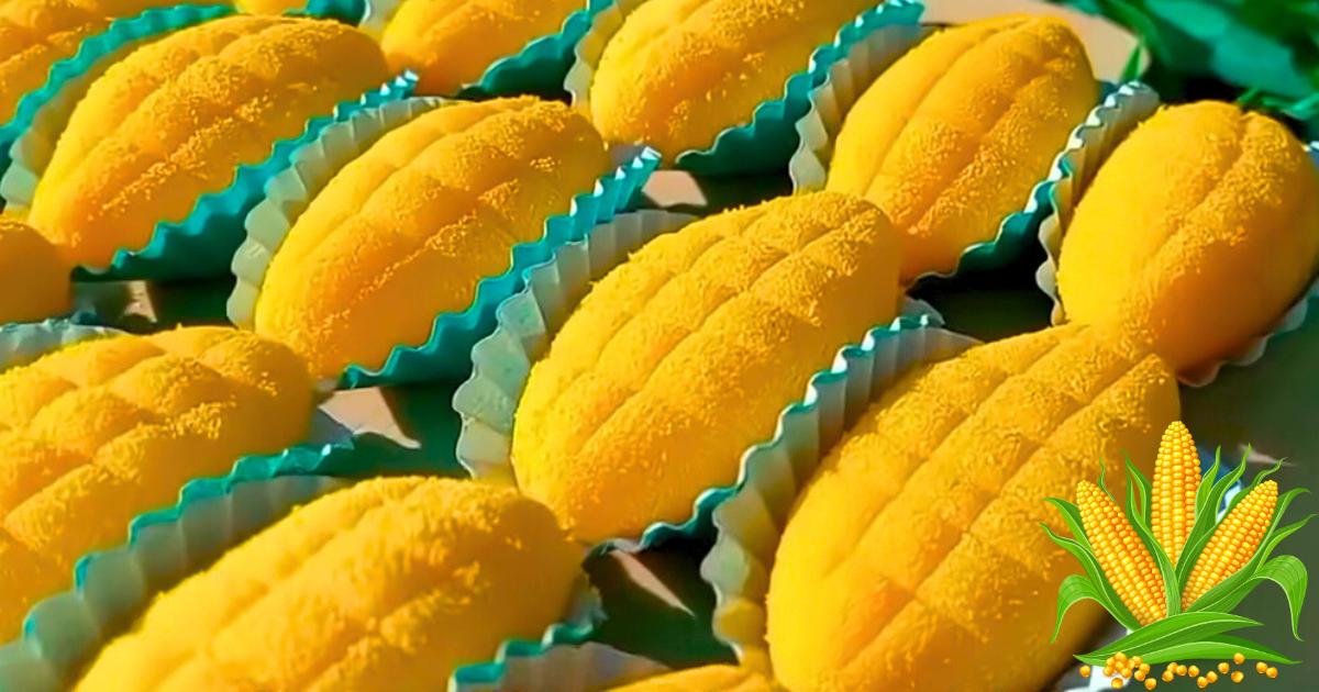 Brigadeiro de milho modelado em forma de espiga, polvilhado com pó amarelo.